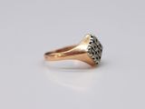 a close up of a gold ring with diamonds on it