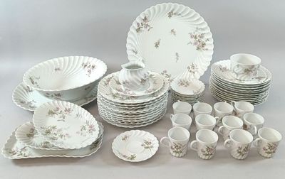 many different types of plates and bowls on the table