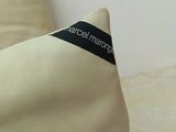 a white pillow with a black label on it