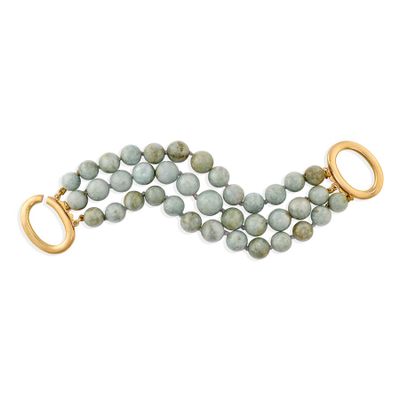 a close up of a bracelet with a gold clasp on a white background