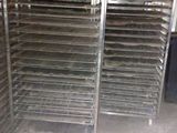 many trays of food that are sitting on the floor
