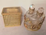 two bottles of perfume sitting next to each other on a table