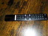 a remote control sitting on a wooden table