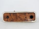 a brown and white vase with holes in it