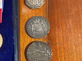a few coins and a medal sitting on a table