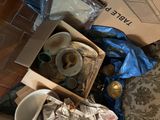 a box of trash and a cup on the floor