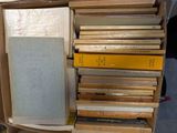 many books stacked on top of each other in a box