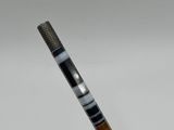 a close up of a golf club with a black and white stripe on it