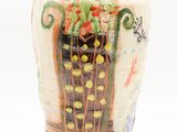 a vase with a painting on it on a white surface