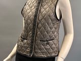 the mannequin is wearing a black skirt and a brown vest