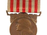 an old medal with a red, white and blue ribbon on it