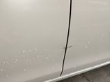 a white car that has some water on the side of it