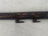 an old wooden knife holder with two knives on top of it