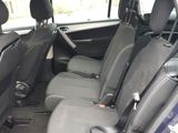 the interior of a small car with four seats and a steering wheel