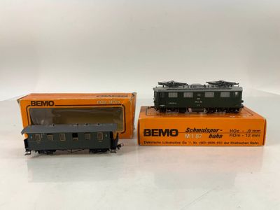 two toy trains sitting on top of a table next to each other