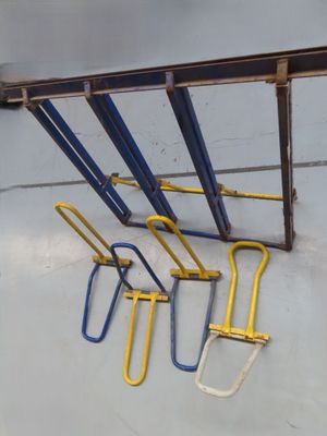 five hand tools hanging from the ceiling of a building