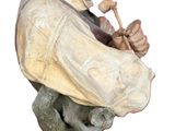 a statue of a man with a pipe in his mouth