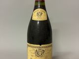 an image of a bottle of wine sitting on top of a table