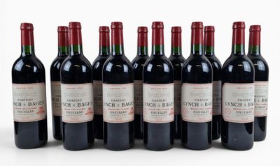 six bottles of red wine lined up in a row on a white surface