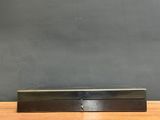 a black metal box sitting on top of a wooden table