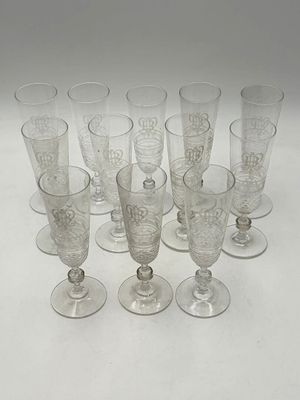 six clear glass goblets sitting on top of a white table