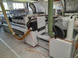 a machine that is working on a piece of paper in a factory