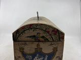 a small box with a bird on it sitting on a table