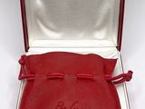 an image of a red leather case with a silver lid