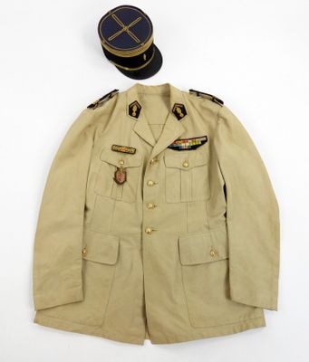 an old military uniform with a hat on top of it