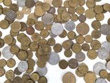 a pile of coins on a table with a white background