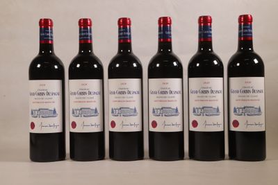 six bouteilles de vin sont alignées sur une table