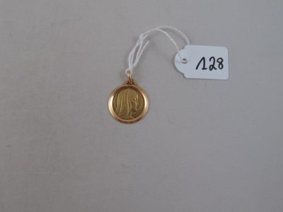 a close up of a gold medal on a white background