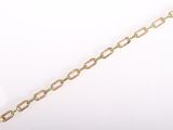 a close up of a gold bracelet with green stones on it
