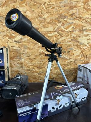 a telescope that is sitting on a table next to a box