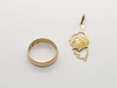 a close up of a gold ring and a gold ring on a white surface