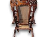 an image of a wooden chair with a wicker seat on a white background