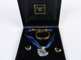an image of a jewelry set in a black box with a blue ribbon
