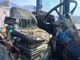 a man that is sitting in the back of a tractor