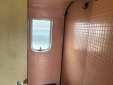 a bathroom with a toilet and a window in it