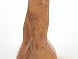 a wooden lamp that is next to a pipe