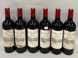 six bottles of wine are lined up in a row on a table