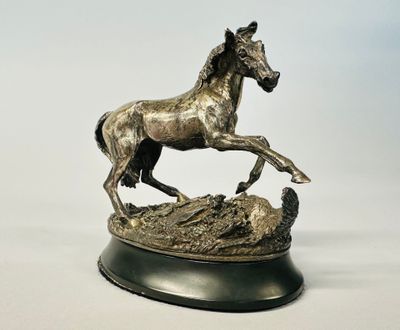 a statue of a horse that is standing on a base