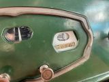 a close up view of the dashboard of an old green car