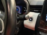 a car dashboard with a steering wheel and a phone in it