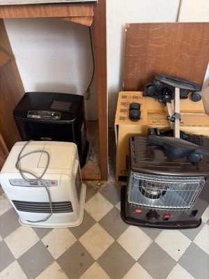 two toasters and a toaster on the floor in a room
