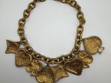 a gold plated bracelet with leaves on it