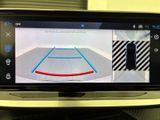 the rear view mirror of a car shows a basketball court on the screen
