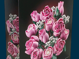 a box with a bunch of pink roses in it