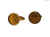 a close up of a pair of gold cufflinks with a coin in the middle