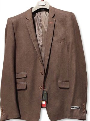 the jacket is brown and has a red tag on it